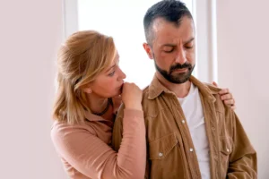 A woman comforts her depressed husband. Here are some ways to nurture your spouse when your spouse is depressed.