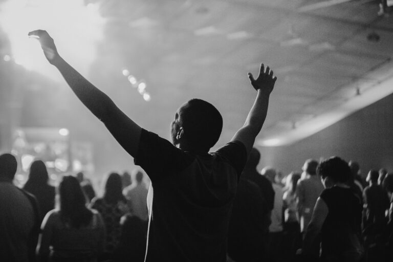 A man lifting his hands in worship.