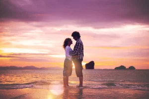 A couple embracing at sunset on the beach, symbolizing true love for your spouse through emotional connection and romantic devotion.