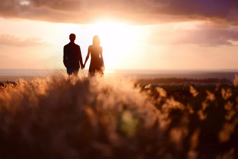 A couple holds hands in the middle of a field in a sunset. Decades of data has shown that premarital sex seems to be associated with a significant elevated risk of divorce. Here's a list of that data on premarital sex and divorce.