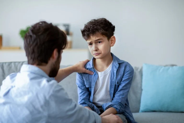 When a child acts out. Young boy and his father talking about his behavioral issues