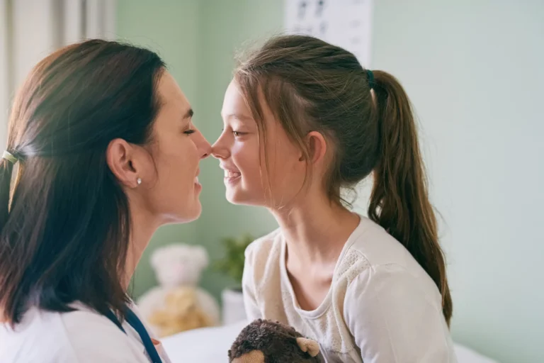 Doctor and child touch one another's nose. Tips to get the best care from your child's doctor