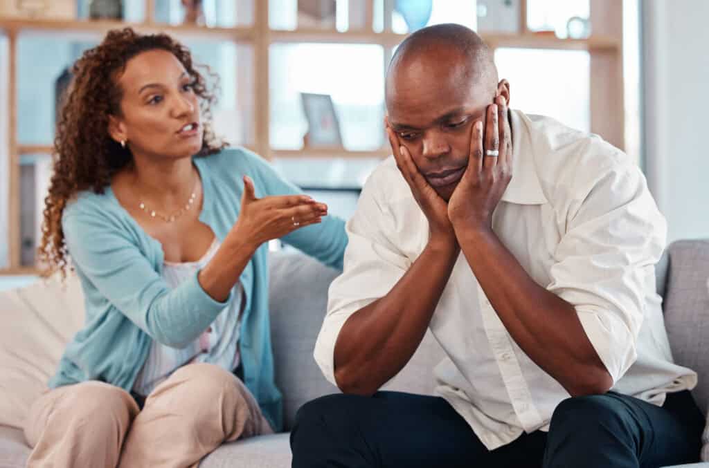 Couple, fight and angry on sofa for marriage problems, conflict and bad communication.