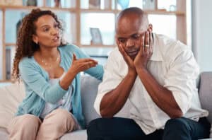 Couple, fight and angry on sofa for marriage problems, conflict and bad communication.