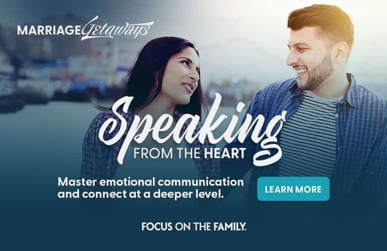 Couple smiling and talking outdoors near a marina - Marriage Getaways Speaking from the Heart