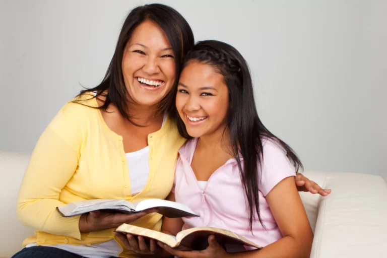 Mother and daughter reading the Bible together as part of raising godly teen disciples through intentional faith practices