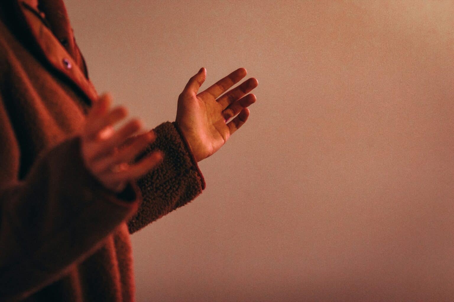 This image shows a person holding their hands up in surrender to the Lord. This is showing us to give up control and have faith over fear in times of change.