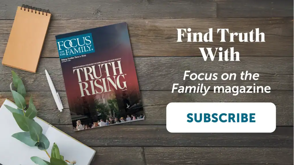 Photograph of Focus on the Family magazine laying on wood table top with brown spiral notebook, white pen, and open blank journal with greenery overlaying. Says "Find Truth with Focus on the Family magazine. Subscribe"