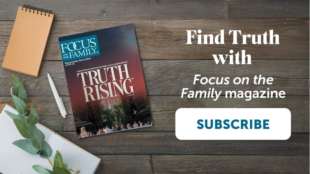 Photograph of Focus on the Family magazine laying on wood table top with brown spiral notebook, white pen, and open blank journal with greenery overlaying. Says "Find Truth with Focus on the Family magazine. Subscribe"