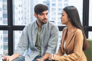 Husband and wife having a serious conversation to reconnect amid busyness in marriage.