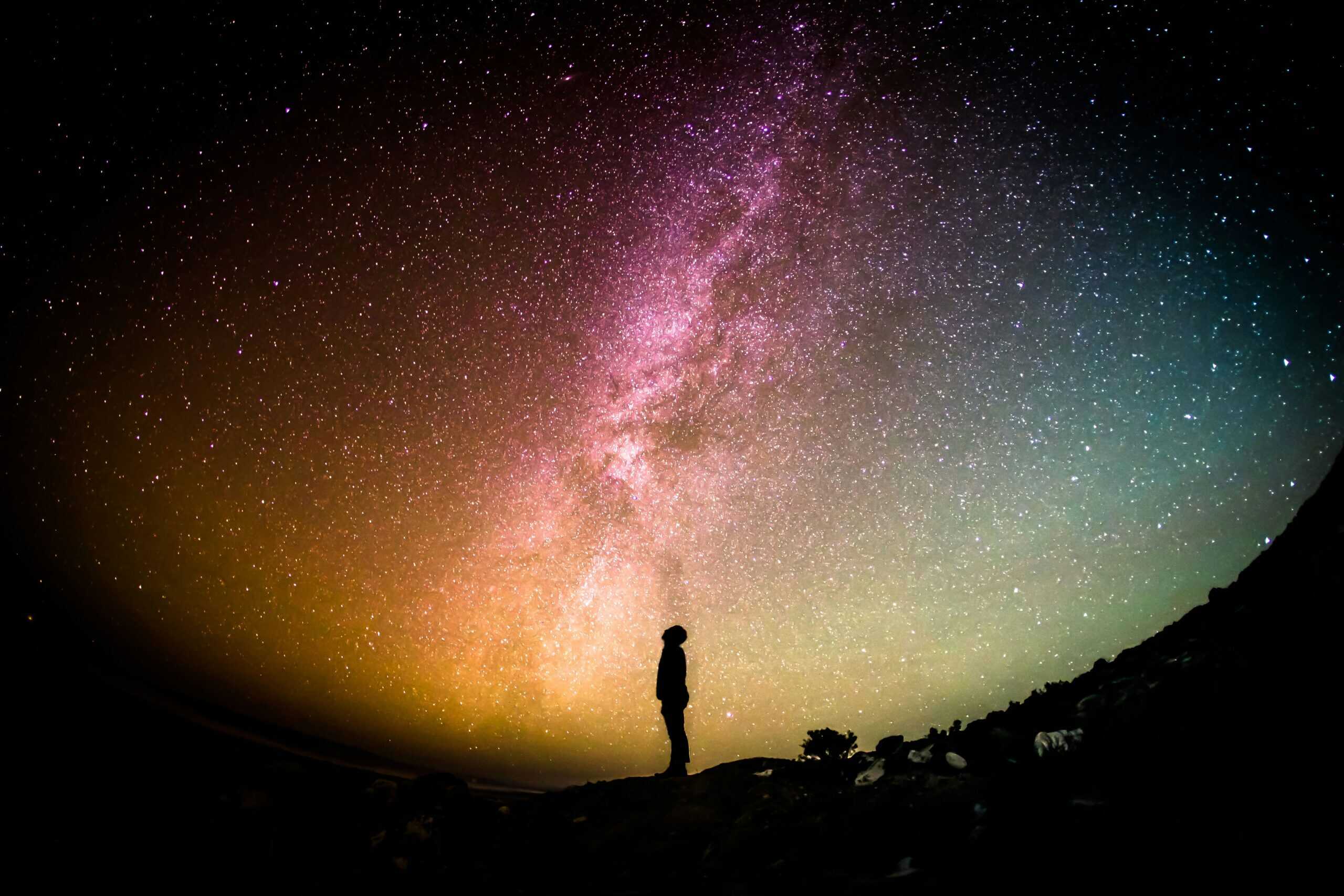 This image shows a person standing under a colorful array of stars. What does the Bible say about astrology? This image shows a person standing under a colorful array of stars. What does the Bible say about astrology?