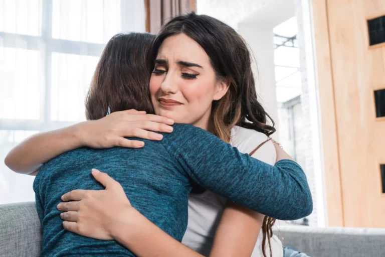 Two women embrace in a moment of emotional support, illustrating the importance of compassion after a sexual assault disclosure.