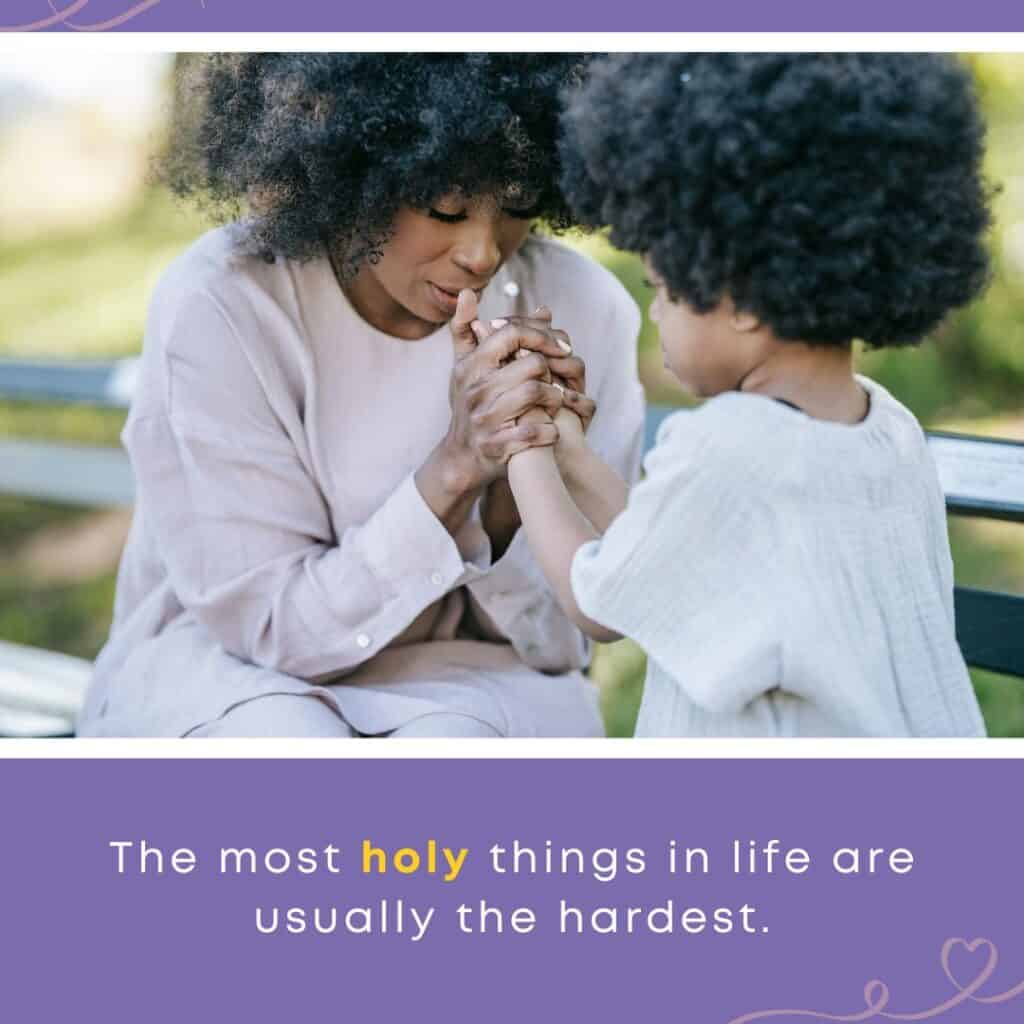 A mother holds her child’s hands in prayer on a park bench, reflecting the challenges and blessings of parenting with patience.