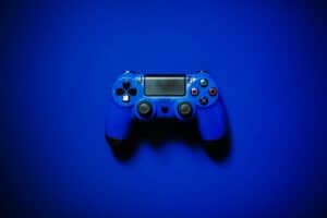 This image shows a blue controller in front of a blue background, set to describe the idea of video games. What does the bible say about video games?