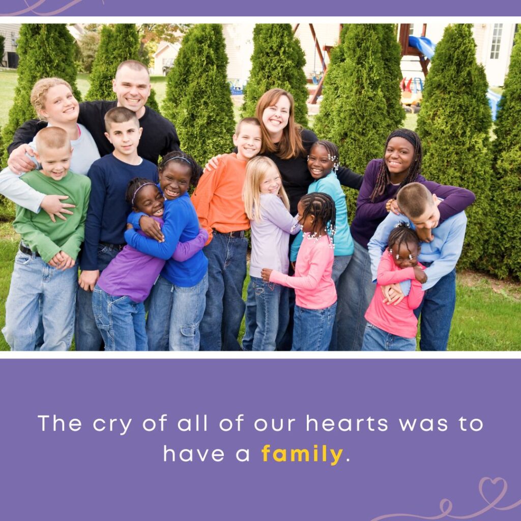 A large, joyful family with parents and children hugging and smiling together outdoors, creating connection through love and belonging.