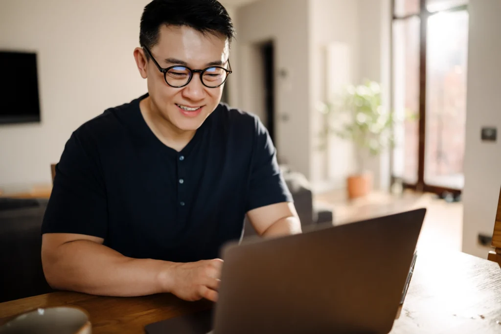Young Asian man working on his laptop