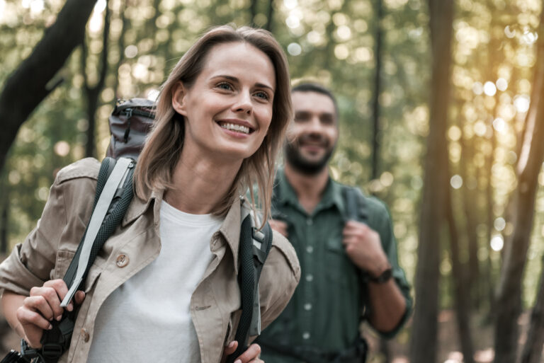 Happy loving couple admiring nature in the forest