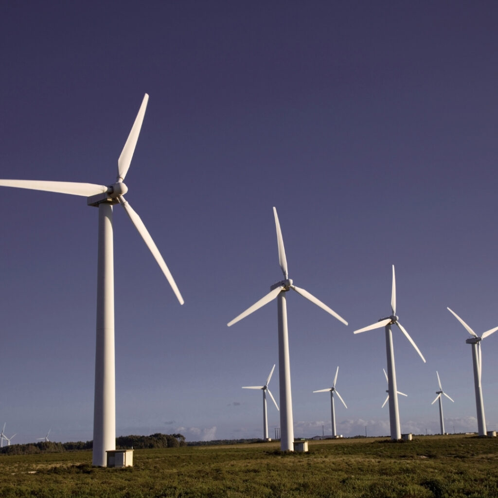 "Child Trafficking: Selling Children Through Abortion and Big Fertility" image with wind turbines and a purple sky.