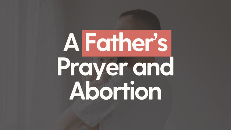 A dark background faded with a father holding their child in his arms, with the white and bold text "A father's prayer and abortion" in the foreground