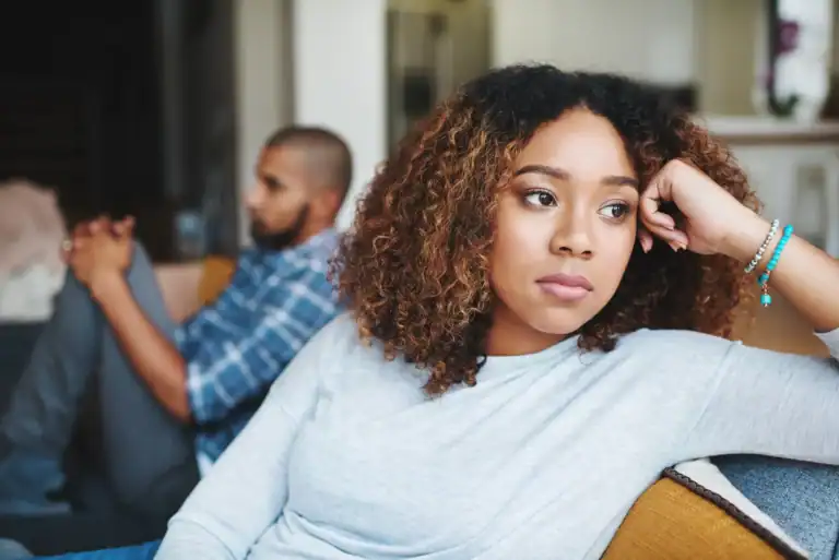 Unhappy couple and sad woman upset after argument or conflict with her man on home sofa and needs a marriage first aid kit to help with disagreements.