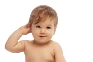 Baby touching his ear, representing early intervention for babies and developmental milestone concerns.