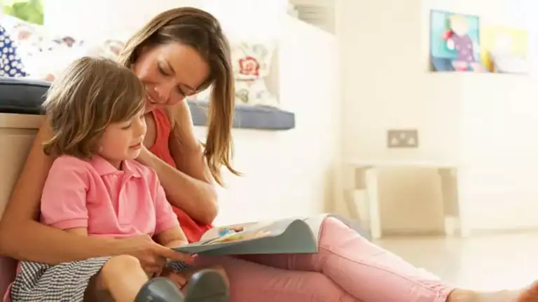 mother praying with toddler