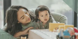 mother playing with autistic toddler