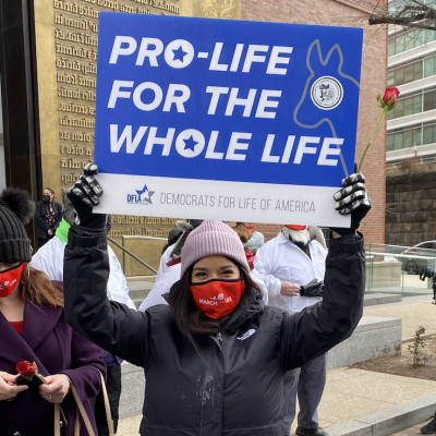pro-life hypocrisy democrat for life stands with a pro-life sign